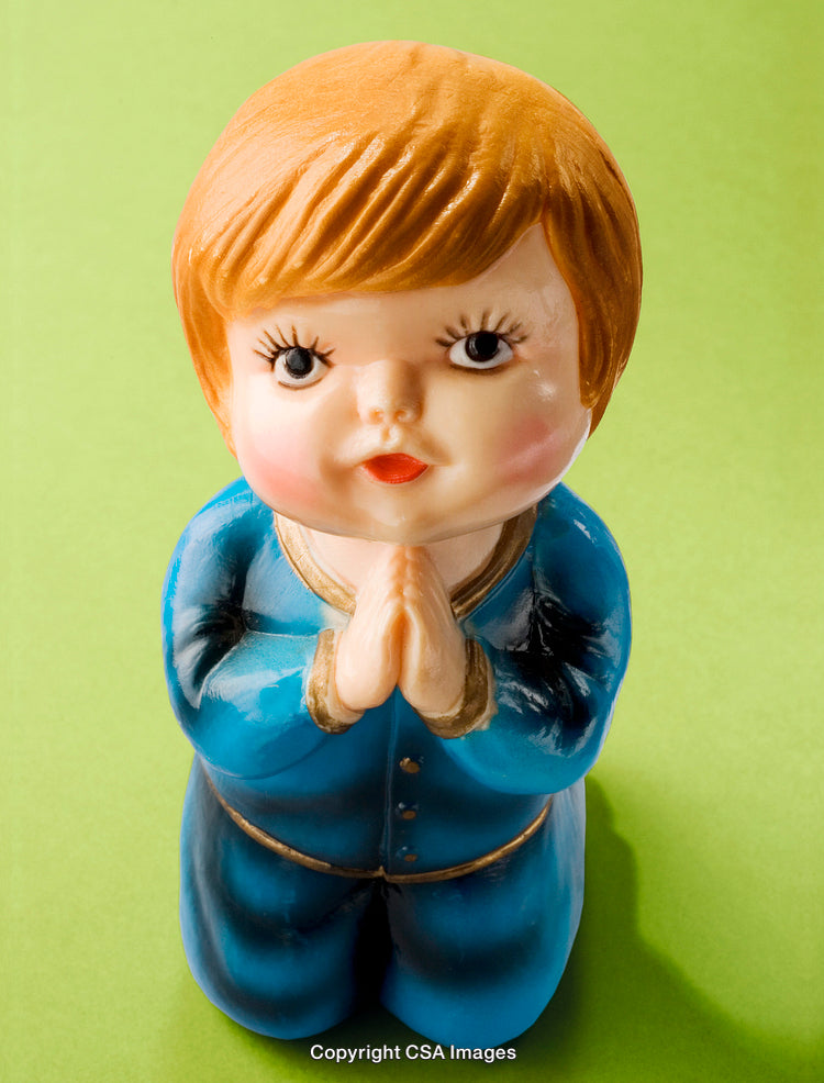 Ceramic Figurine of a Child Praying on a Green Background
