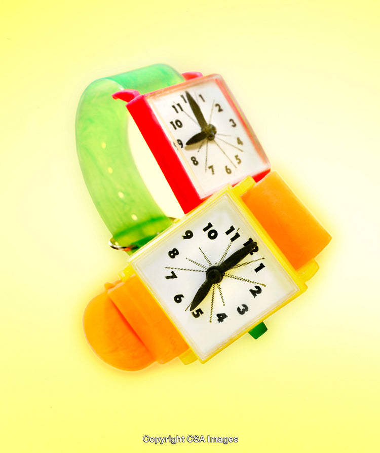 Colorful Toy Wristwatch with Bright Plastic Design on Yellow Background