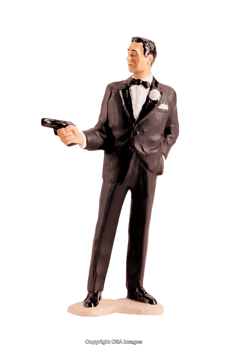 Elegant Toy Plastic Figure in Tuxedo Holding a Pistol on White Background