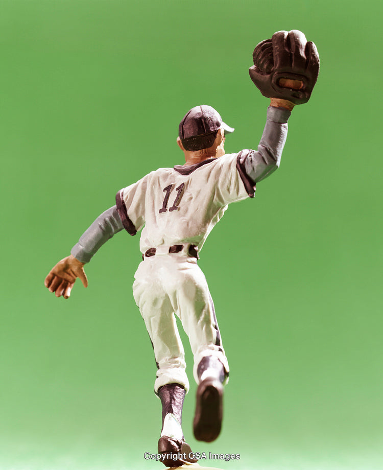 Action Figure Baseball Player Against Green Background