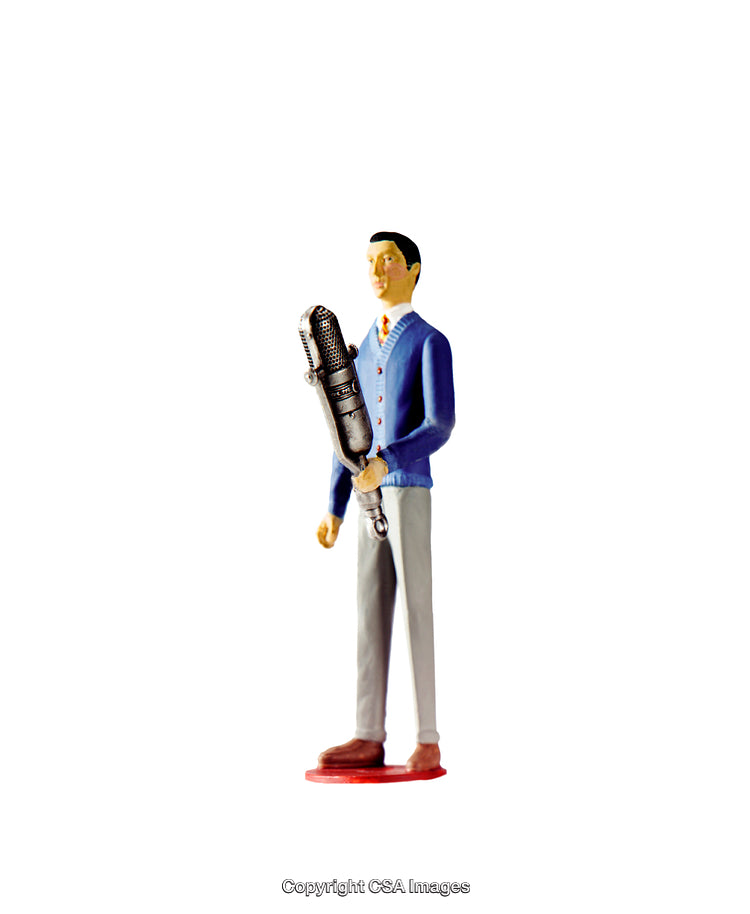 Miniature Figure Holding Microphone Representing Public Speaking or Broadcasting