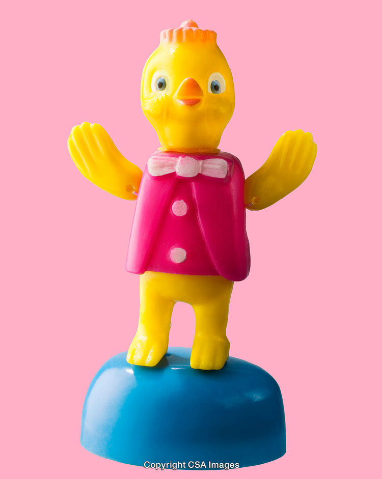 Colorful Plastic Toy Chick Standing on Blue Base