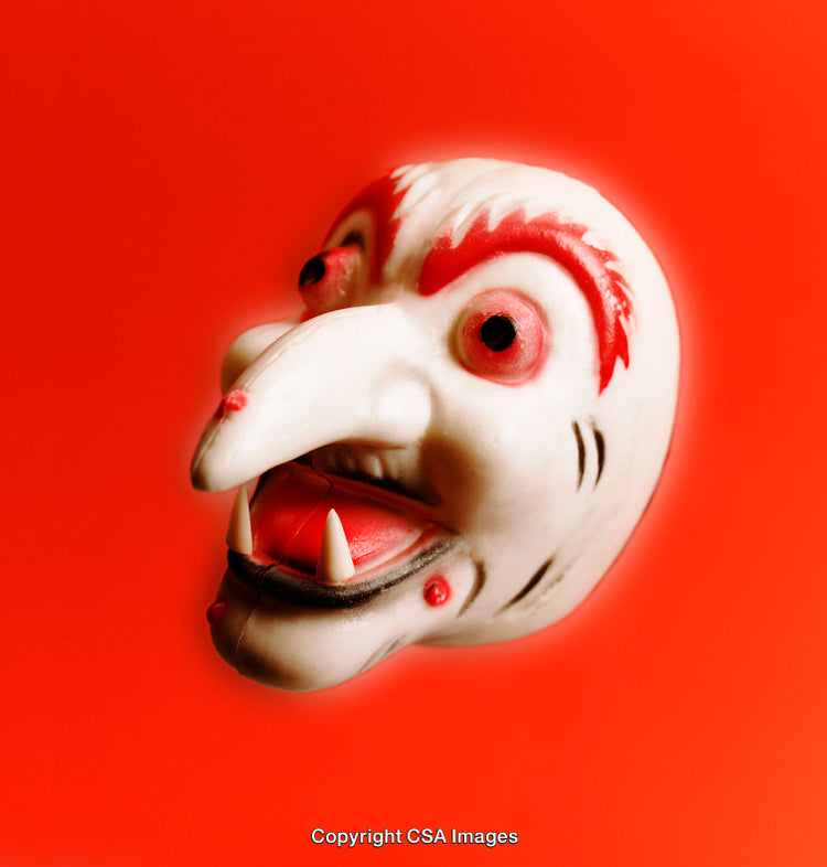 Close-Up of a Monster Mask on Red Background