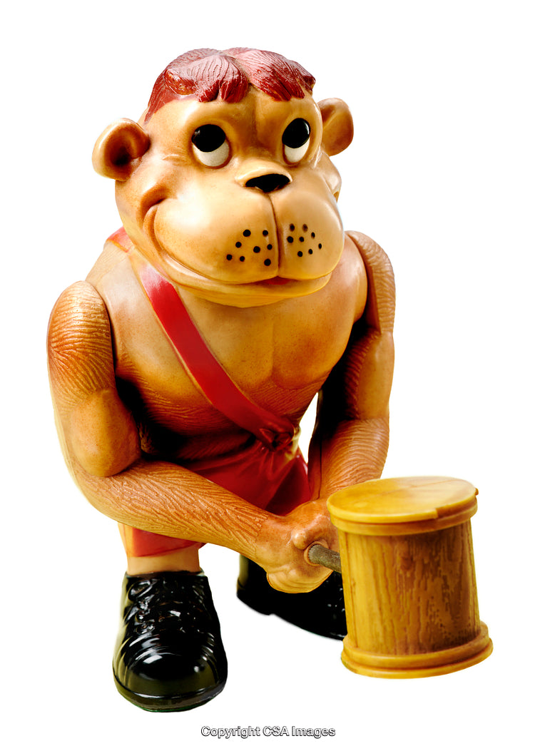 Close-Up of a Plastic Monkey Toy Holding a Wooden Mallet