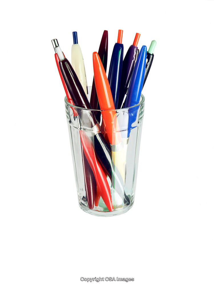 Collection of Colorful Pens in a Clear Glass Container on White Background
