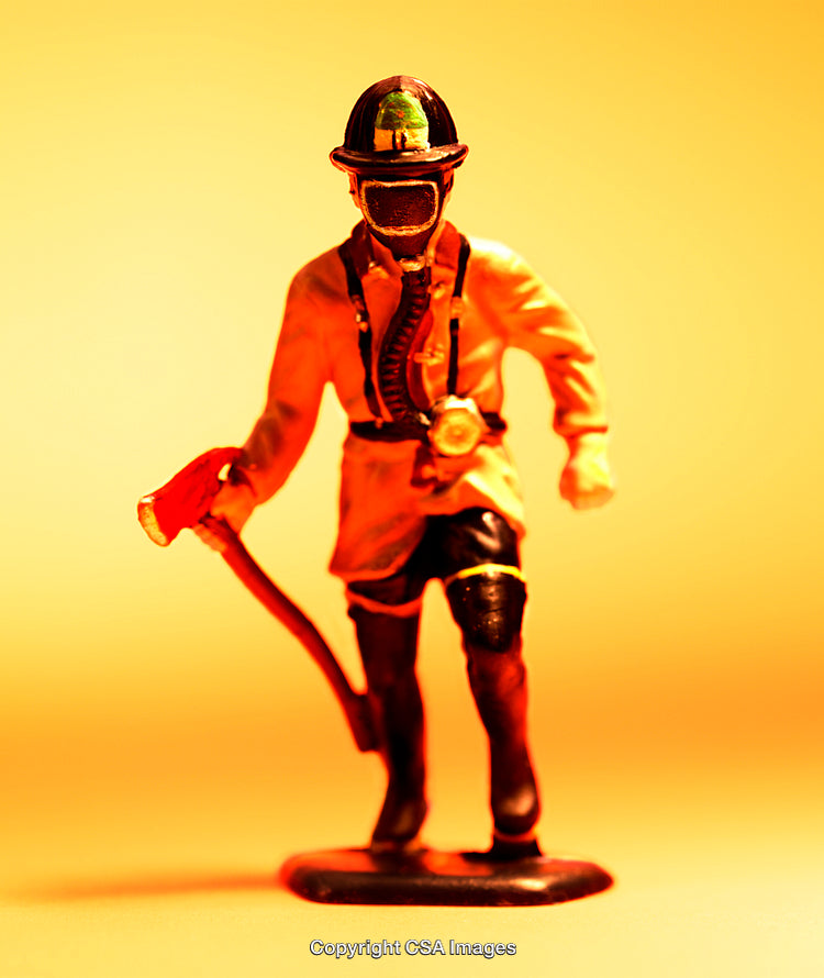 Close-Up of a Firefighter Figurine on an Orange Background