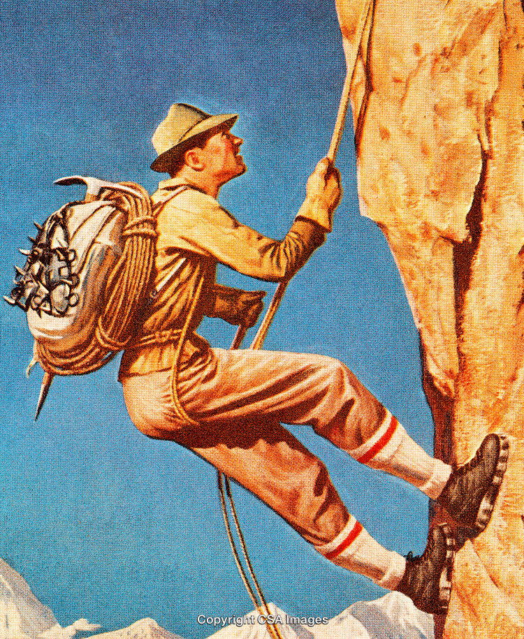Man Rock Climbing Outdoors on a Sunny Day in the Mountains