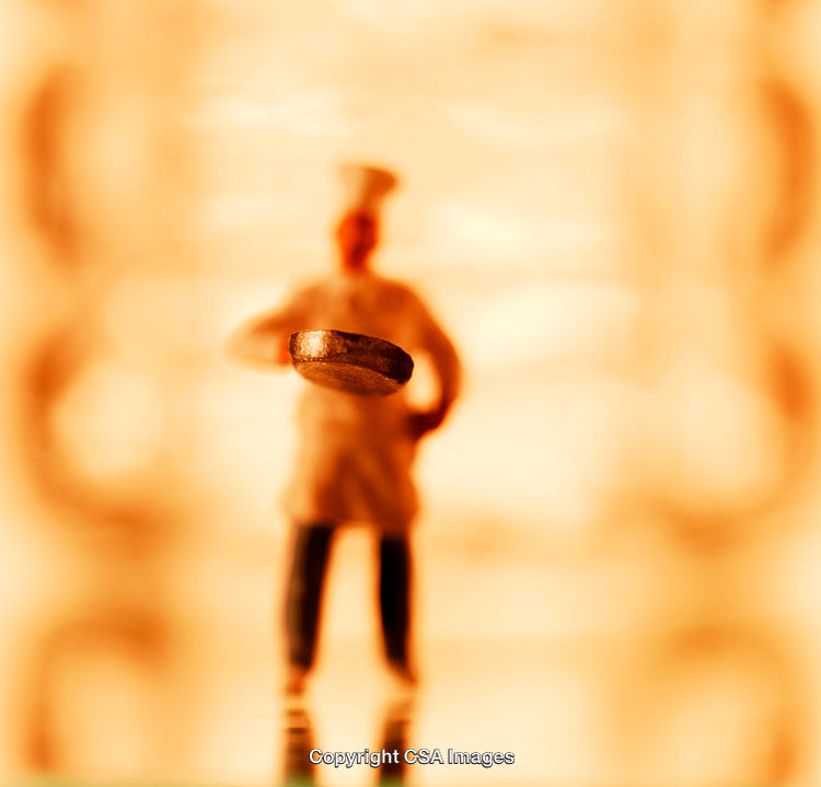 Artistic Close-Up of a Chef Figurine with Emphasis on the Pan