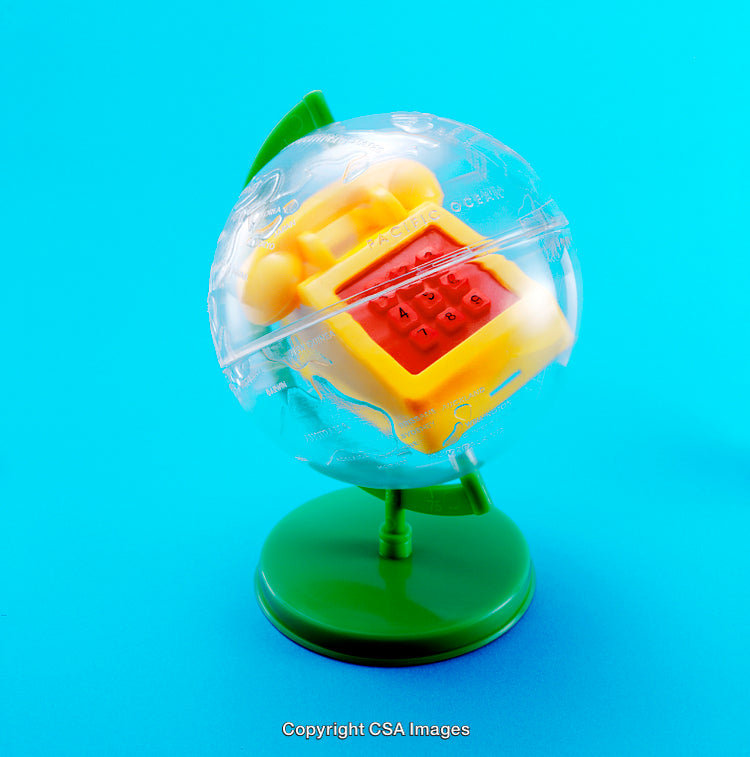 Plastic Toy Globe With Embedded Telephone on Blue Background