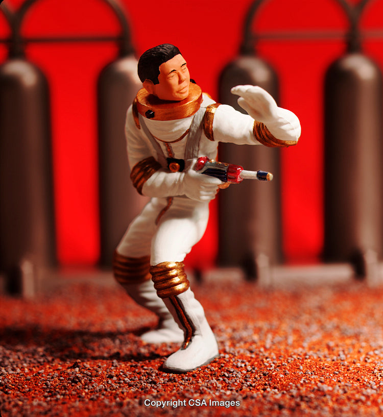 Action Figure of Space Explorer with Futuristic Weapon in Red Alien Terrain