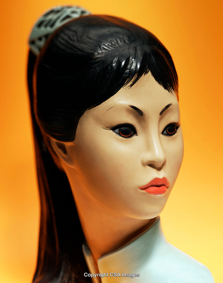 Elegant Ceramic Figure of a Woman Against Vibrant Orange Background